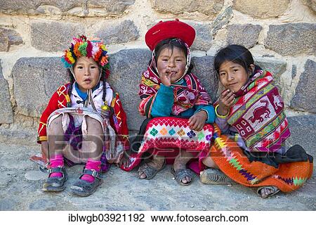 "Three children in traditional dress of the Quechua Indians sit in front of a wall, Ollantaytambo, Urubamba Valley, Peru, South America" View Large Photo Image Stock Image - "Three children in traditional dress of the Quechua Indians sit in front of a wall, Ollantaytambo, Urubamba Valley, Peru, South America". Fotosearch