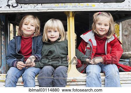 "Three children sitting in a disused bus, Esslingen, Baden-Wurttemberg, Germany, Europe" View Large Photo Image Stock Image - "Three children sitting in a disused bus, Esslingen, Baden-Wurttemberg, Germany, Europe". Fotosearch