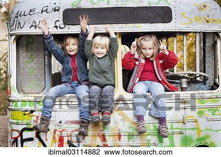 "Three children sitting in a disused bus, Esslingen, Baden-Wurttemberg, Germany, Europe" View Large Photo Image Stock Image - "Three children sitting in a disused bus, Esslingen, Baden-Wurttemberg, Germany, Europe". Fotosearch