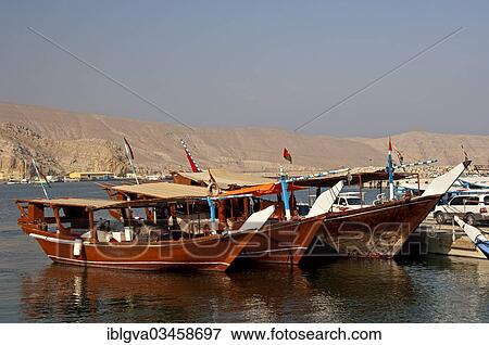 "Three dhows are ready for excursions in the port of al-Khasab or al-Chasab, Khasab, Musandam Governorate, Oman, Asia" View Large Photo Image Stock Photo - "Three dhows are ready for excursions in the port of al-Khasab or al-Chasab, Khasab, Musandam Governorate, Oman, Asia". Fotosearch
