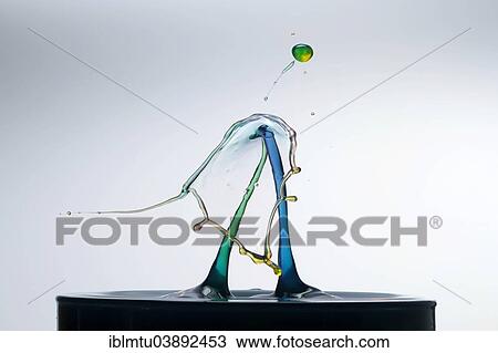 Stock Image - Three different coloured drops colliding. Fotosearch