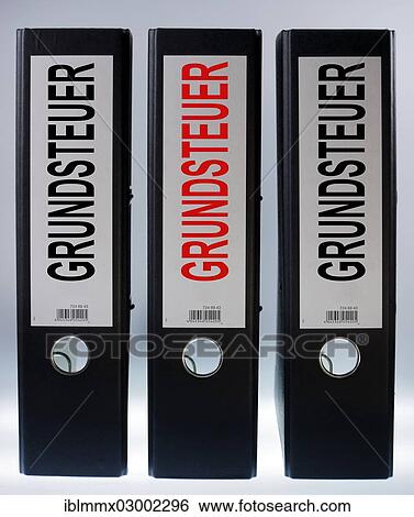 Stock Photograph - "Three file folders labeled """"Grundsteuer"""", German for """"land tax""""". Fotosearch
