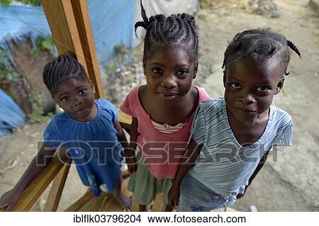 "Three girls, two with cornrows, Tchawa, Leogane, Haiti, North America" View Large Photo Image Picture - "Three girls, two with cornrows, Tchawa, Leogane, Haiti, North America". Fotosearch
