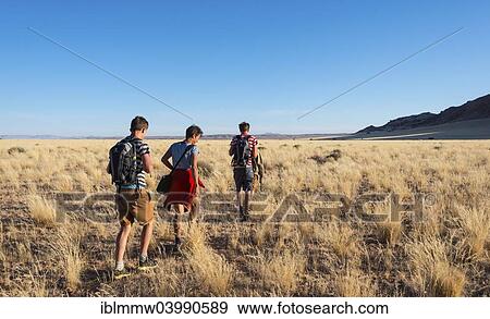 "Three hikers in the savannah near the Naukluft Mountains, Namib-Naukluft, Namibia, Africa" View Large Photo Image Stock Photo - "Three hikers in the savannah near the Naukluft Mountains, Namib-Naukluft, Namibia, Africa". Fotosearch