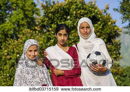"Three Kashmiri girls, one holding a soccer ball, two wearing headscarves, Srinagar, Jammu and Kashmir, India, Asia" View Large Photo Image Stock Photo - "Three Kashmiri girls, one holding a soccer ball, two wearing headscarves, Srinagar, Jammu and Kashmir, India, Asia". Fotosearch