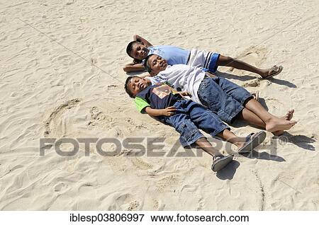 "Three Kuna Indian boys lying in the sand, Nalunega, San Blas Islands, Panama, North America" View Large Photo Image Stock Photo - "Three Kuna Indian boys lying in the sand, Nalunega, San Blas Islands, Panama, North America". Fotosearch