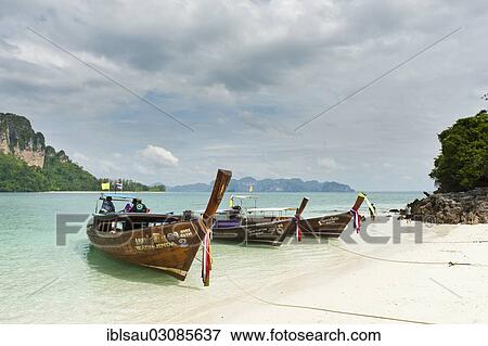 Stock Photo - "Three longtail boats on a white sandy beach, Insel Tup, Ao Nang, Krabi Province, Southern Thailand, Thailand, Asia". Fotosearch