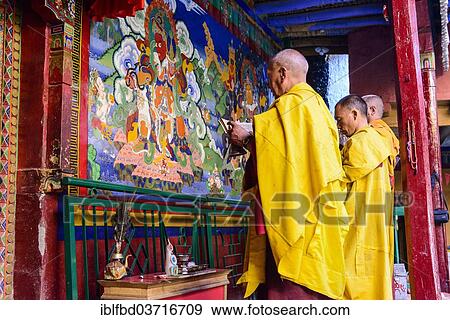 "Three monks of Lamayuru Gompa are praying in front of a colorful religious wall painting, Ladakh, Jammu and Kashmir, India, Asia" View Large Photo Image Stock Photo - "Three monks of Lamayuru Gompa are praying in front of a colorful religious wall painting, Ladakh, Jammu and Kashmir, India, Asia". Fotosearch