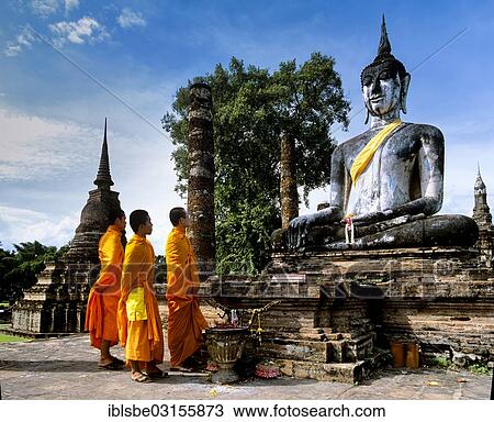 "Three monks standing in front of the seated Buddha at Wat Mahathat, temple ruins, pillars, chedi, Sukhothai Historical Park, Sukhothai, Sukhothai Province, Northern Thailand, Thailand, Asia" View Large Photo Image Stock Image - "Three monks standing in front of the seated Buddha at Wat Mahathat, temple ruins, pillars, chedi, Sukhothai Historical Park, Sukhothai, Sukhothai Province, Northern Thailand, Thailand, Asia". Fotosearch