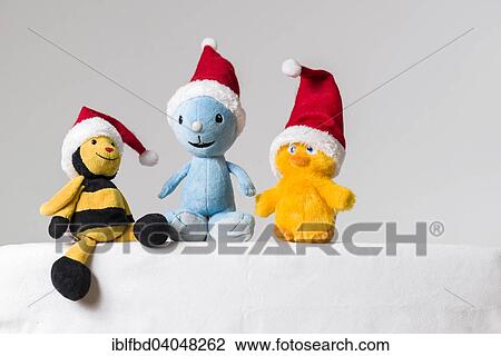 Three plush toys wearing Santa Claus hats View Large Photo Image Stock Image - Three plush toys wearing Santa Claus hats. Fotosearch