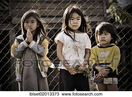 "Three sad girls in front of a fence in Laos, Southeast Asia, Asia" View Large Photo Image Stock Image - "Three sad girls in front of a fence in Laos, Southeast Asia, Asia". Fotosearch