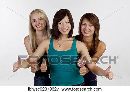 "Three smiling young women, making thumbs up gesture" View Large Photo Image Stock Photo - "Three smiling young women, making thumbs up gesture". Fotosearch