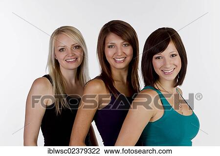 Stock Image - "Three smiling young women, portrait". Fotosearch