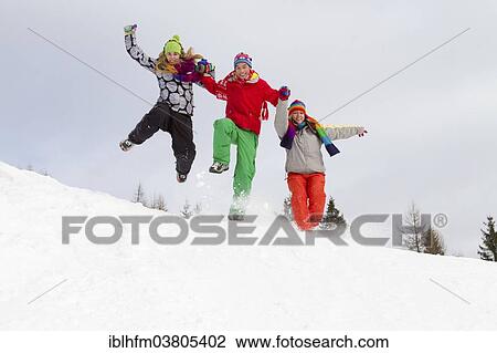 "Three young adults in colorful winter clothes jumping in the snow, Carinthia, Austria, Europe" View Large Photo Image Stock Image - "Three young adults in colorful winter clothes jumping in the snow, Carinthia, Austria, Europe". Fotosearch