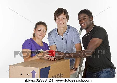"Three young people of different colours of skin, house moving" View Large Photo Image Picture - "Three young people of different colours of skin, house moving". Fotosearch