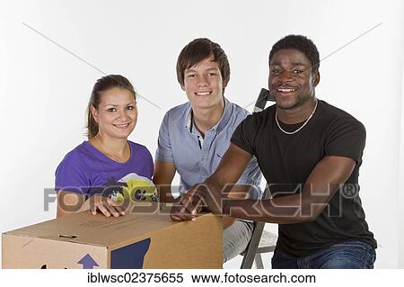 Stock Photography - Three young people on moving day. Fotosearch