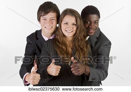 Stock Image - Three young people with different skin colors giving a thumbs up. Fotosearch