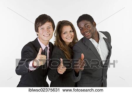 Stock Image - Three young people with different skin colors giving a thumbs up. Fotosearch