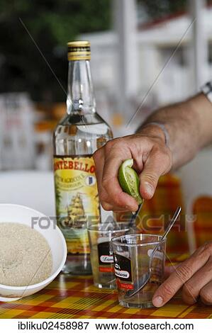 Stock Photo - "Ti Punch, national drink with lime, sugar and rum being prepared, Guadeloupe, Caribbean, Lesser Antilles, North America". Fotosearch