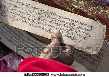 "Tibetean monk reading the holy scriptures in Tibetan language, at the foot of Boudnath Stupa, Kathmandu Valley, Kathmandu, Kathmandu District, Bagmati Zone, Nepal, Asia" View Large Photo Image Stock Image - "Tibetean monk reading the holy scriptures in Tibetan language, at the foot of Boudnath Stupa, Kathmandu Valley, Kathmandu, Kathmandu District, Bagmati Zone, Nepal, Asia". Fotosearch
