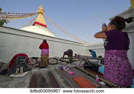 Stock Photo - "Tibetean pilgrims practicing prostrations at the foot of Boudnath Stupa, Kathmandu Valley, Kathmandu, Kathmandu District, Bagmati Zone, Nepal, Asia". Fotosearch