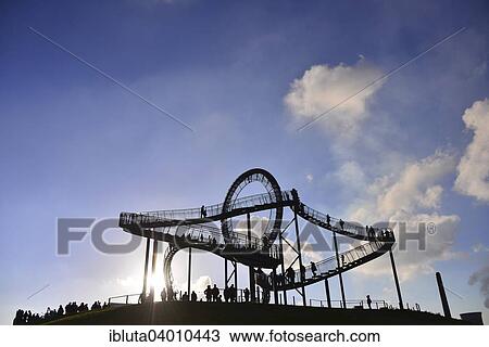 "Tiger and Turtle - Magic Mountain, landmark at the Heinrich-Hildebrand-Hohe, during celebration of the first anniversary, Duisburg, North Rhine-Westphalia, Germany, Europe" View Large Photo Image Stock Image - "Tiger and Turtle - Magic Mountain, landmark at the Heinrich-Hildebrand-Hohe, during celebration of the first anniversary, Duisburg, North Rhine-Westphalia, Germany, Europe". Fotosearch