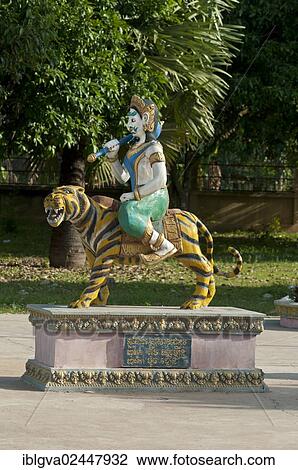 Stock Image - "Tiger sculpture with riders as a symbol of the third of the twelve earthly branches in the Chinese calendar in a Buddhist monastery, Areyskat near Phnom Penh, Cambodia, Southeast Asia, Asia". Fotosearch