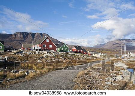Stock Photo - "Timber houses, with mountains at the back, Qeqertarsuaq, Greenland, North America". Fotosearch