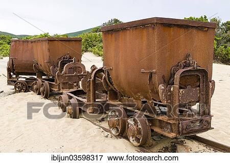 Stock Photo - "Tippers or tipping wagons on old mine tracks in the dunes, Dune di Piscinas d'Ingurtosu, Arbus, Sardinia, Italy, Europe". Fotosearch