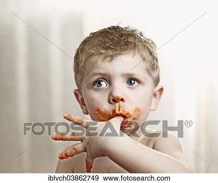 Toddler licking tomato sauce off his thumb View Large Photo Image Stock Photo - Toddler licking tomato sauce off his thumb. Fotosearch