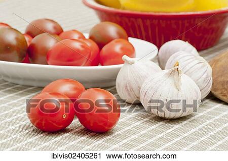 Stock Image - Tomatoes and garlic on a table. Fotosearch