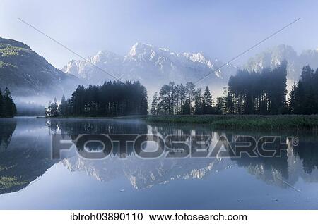 Stock Image - "Totes Gebirge, dead mountains range with reflections in Alpsee Lake, Almtal Valley, Upper Austria, Austria, Europe". Fotosearch