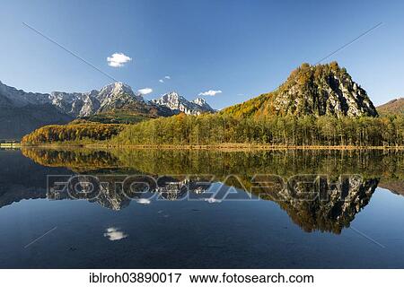Stock Photo - "Totes Gebirge, dead mountains range with reflections in Alpsee Lake, Almtal Valley, Upper Austria, Austria, Europe". Fotosearch