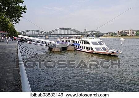 "Tour boat at a dock on the bank of the Rhine River, Hohenzollern Bridge, Cologne, Rhineland, North Rhine-Westphalia, Germany, Europe" View Large Photo Image Stock Photo - "Tour boat at a dock on the bank of the Rhine River, Hohenzollern Bridge, Cologne, Rhineland, North Rhine-Westphalia, Germany, Europe". Fotosearch