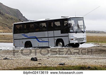 Tourist bus driving through water, Landmannalaugar, Iceland, Europe View Large Photo Image Stock Photo - Tourist bus driving through water, Landmannalaugar, Iceland, Europe. Fotosearch