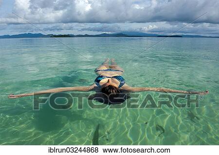 "Tourist floating in the clear water of the Marovo Lagoon, Marovo Lagoon, Western Province, Solomon Islands, Oceania" View Large Photo Image Stock Photo - "Tourist floating in the clear water of the Marovo Lagoon, Marovo Lagoon, Western Province, Solomon Islands, Oceania". Fotosearch
