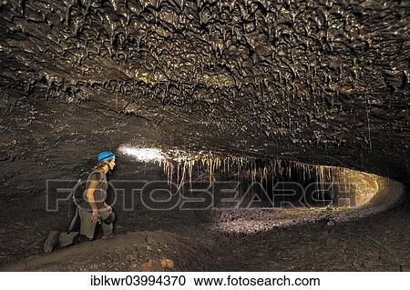 "Tourist in a subterranean lava tube created by an eruption of the Piton de la Fournaise volcano, Le Grand Brule, Reunion, Africa" View Large Photo Image Stock Image - "Tourist in a subterranean lava tube created by an eruption of the Piton de la Fournaise volcano, Le Grand Brule, Reunion, Africa". Fotosearch