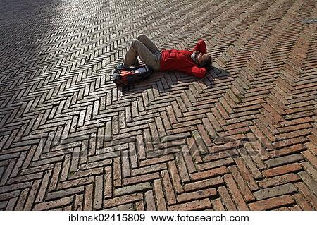 Tourist lying in the Piazza del Campo square, Siena, Tuscany region, province of Siena, Italy, Europe View Large Photo Image Stock Photo - Tourist lying in the Piazza del Campo square, Siena, Tuscany region, province of Siena, Italy, Europe. Fotosearch