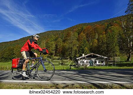 "Tourist on a bicycle cycling on front of a hut, Seegatterl, Reit im Winkl, Chiemgau, Upper Bavaria, Bavaria, Germany, Europe" View Large Photo Image Stock Image - "Tourist on a bicycle cycling on front of a hut, Seegatterl, Reit im Winkl, Chiemgau, Upper Bavaria, Bavaria, Germany, Europe". Fotosearch