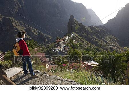 "Tourist overlooking the mountain village of Masca, Tenerife, Canary Islands, Spain, Europe" View Large Photo Image Stock Image - "Tourist overlooking the mountain village of Masca, Tenerife, Canary Islands, Spain, Europe". Fotosearch