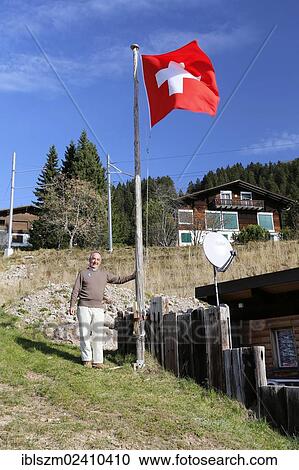 "Tourist standing beside a Swiss flag, Rigi Kaltbad, Switzerland, Europe" View Large Photo Image Stock Image - "Tourist standing beside a Swiss flag, Rigi Kaltbad, Switzerland, Europe". Fotosearch