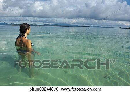 "Tourist standing in the clear water of the Marovo Lagoon, Marovo Lagoon, Western Province, Solomon Islands, Oceania" View Large Photo Image Stock Image - "Tourist standing in the clear water of the Marovo Lagoon, Marovo Lagoon, Western Province, Solomon Islands, Oceania". Fotosearch