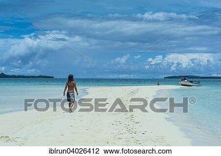 "Tourist walking on a sand strip at low tide, Rock Islands, Palau, Oceania" View Large Photo Image Stock Image - "Tourist walking on a sand strip at low tide, Rock Islands, Palau, Oceania". Fotosearch