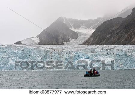 "Tourists and guides in an inflatable boat, Waggonway Glacier, Magdalene Fjord, Spitsbergen Island, Svalbard Archipelago, Svalbard and Jan Mayen, Norway, Europe" View Large Photo Image Stock Photo - "Tourists and guides in an inflatable boat, Waggonway Glacier, Magdalene Fjord, Spitsbergen Island, Svalbard Archipelago, Svalbard and Jan Mayen, Norway, Europe". Fotosearch