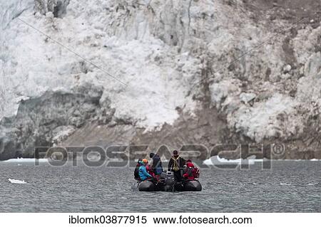 "Tourists and guides in an inflatable boat, Waggonway Glacier, Magdalene Fjord, Spitsbergen Island, Svalbard Archipelago, Svalbard and Jan Mayen, Norway, Europe" View Large Photo Image Stock Photography - "Tourists and guides in an inflatable boat, Waggonway Glacier, Magdalene Fjord, Spitsbergen Island, Svalbard Archipelago, Svalbard and Jan Mayen, Norway, Europe". Fotosearch