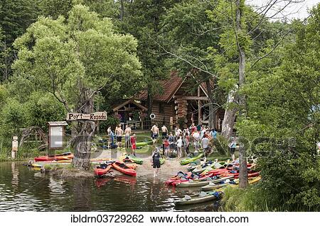 "Tourists at a boat rental place at the Krutynia River, Ukta, Warmian-Masurian Voivodeship, Poland, Poland, Europe" View Large Photo Image Stock Image - "Tourists at a boat rental place at the Krutynia River, Ukta, Warmian-Masurian Voivodeship, Poland, Poland, Europe". Fotosearch