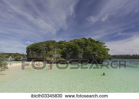 "Tourists bathing in front of the sacred rock on the Ile des Pins, Ile des Pins, New Caledonia, France, Oceania" View Large Photo Image Stock Image - "Tourists bathing in front of the sacred rock on the Ile des Pins, Ile des Pins, New Caledonia, France, Oceania". Fotosearch
