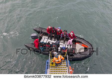 "Tourists being helped out of an inflatable boat, Spitsbergen Island, Svalbard Archipelago, Svalbard and Jan Mayen, Norway, Europe" View Large Photo Image Stock Image - "Tourists being helped out of an inflatable boat, Spitsbergen Island, Svalbard Archipelago, Svalbard and Jan Mayen, Norway, Europe". Fotosearch