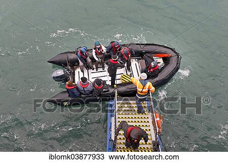 "Tourists being helped out of an inflatable boat, Spitsbergen Island, Svalbard Archipelago, Svalbard and Jan Mayen, Norway, Europe" View Large Photo Image Stock Image - "Tourists being helped out of an inflatable boat, Spitsbergen Island, Svalbard Archipelago, Svalbard and Jan Mayen, Norway, Europe". Fotosearch