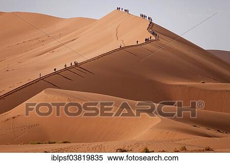 "Tourists climbing the Sossusvlei Dunes, Namib-Naukluft National Park, Namibia, Africa" View Large Photo Image Stock Photography - "Tourists climbing the Sossusvlei Dunes, Namib-Naukluft National Park, Namibia, Africa". Fotosearch